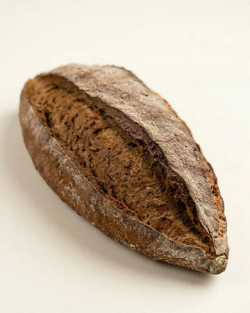 Loaf of bread with a textured surface on a light background